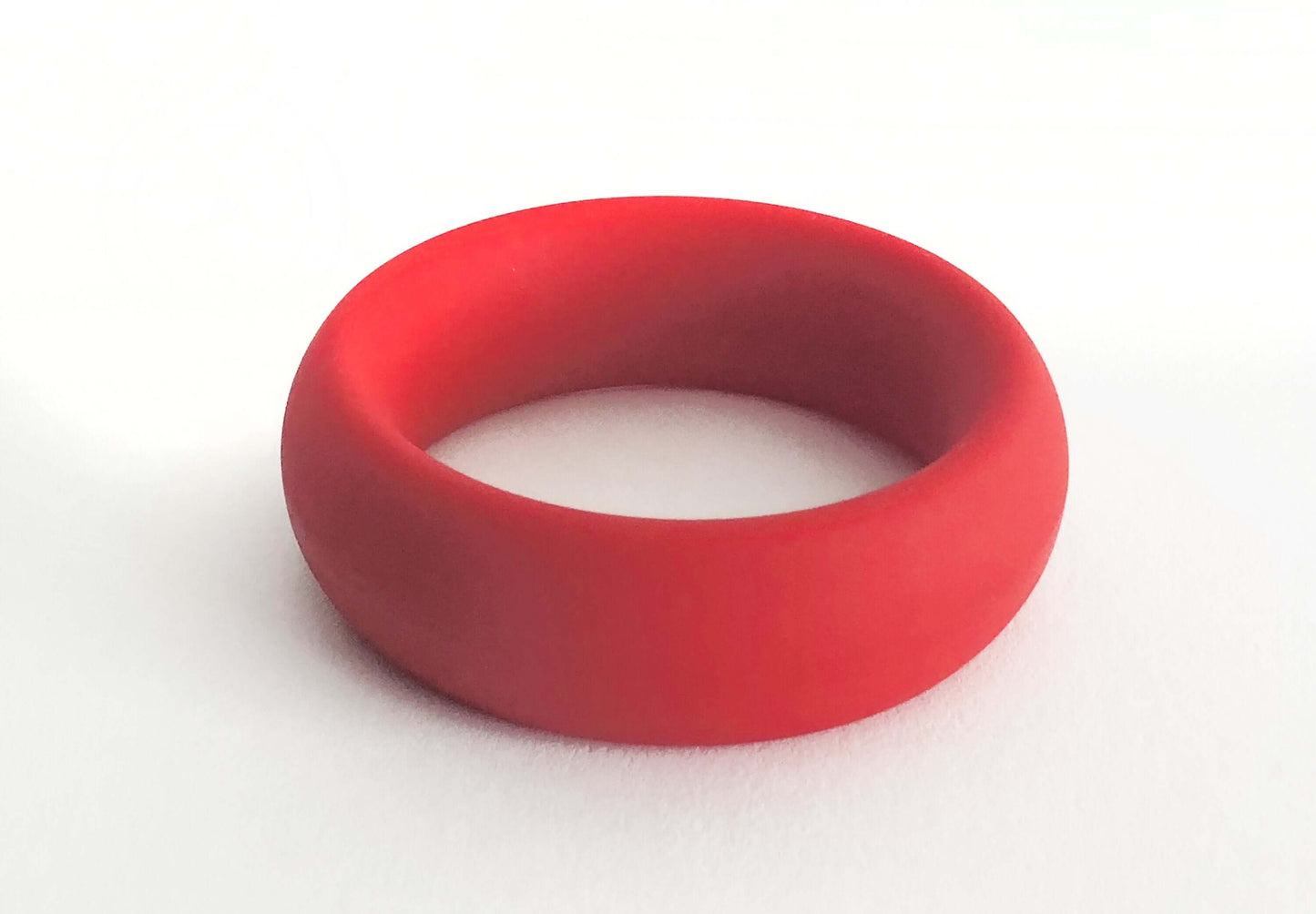 Red silicone cock ring known as The Meat Rack, featuring a thick girth and non-roll design for enhanced performance.