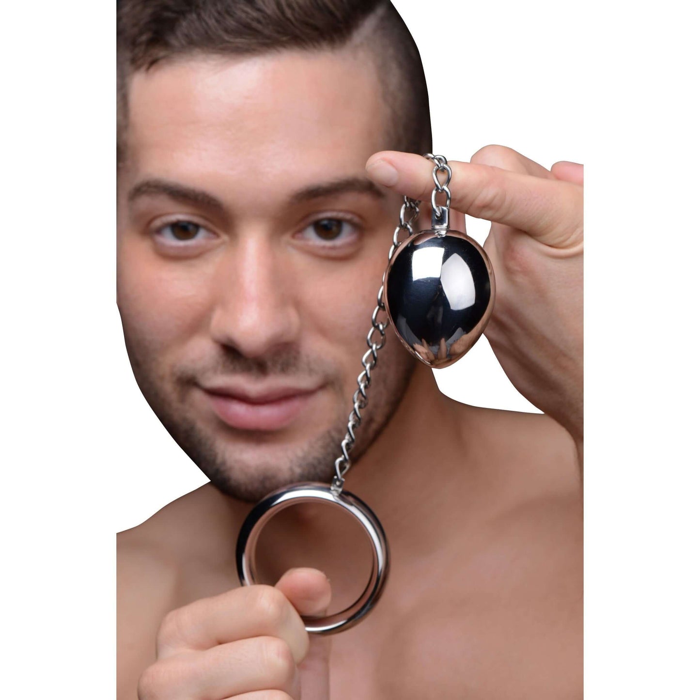Man holding a stainless steel cock ring and anal plug, showcasing dual stimulation pleasure accessory.
